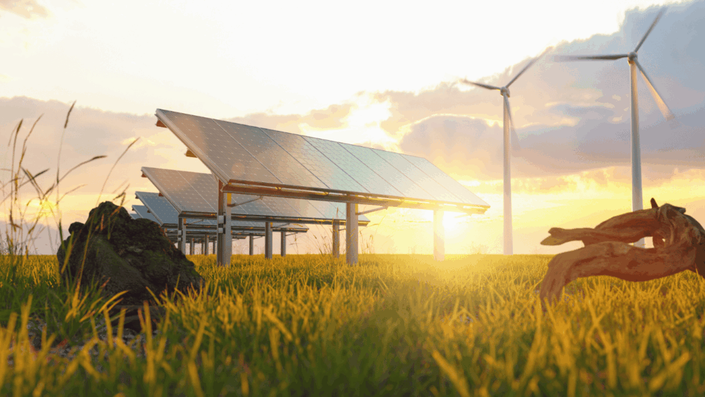 Solar panels and wind turbines in a sunlit field at dusk, representing sustainable energy solutions and opportunities for Long-term investing in green technology.