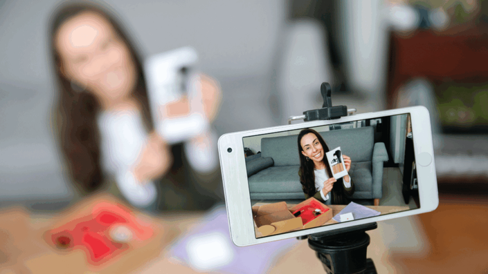 Female influencer smiling and engaging with the camera while authentically using a product, showcasing effective influencer marketing.