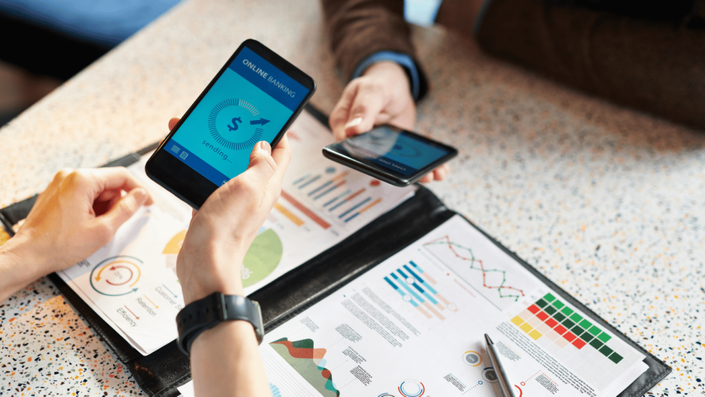Two smartphones showing online banking transactions, illustrating how Finance apps enable secure digital transactions and financial management.